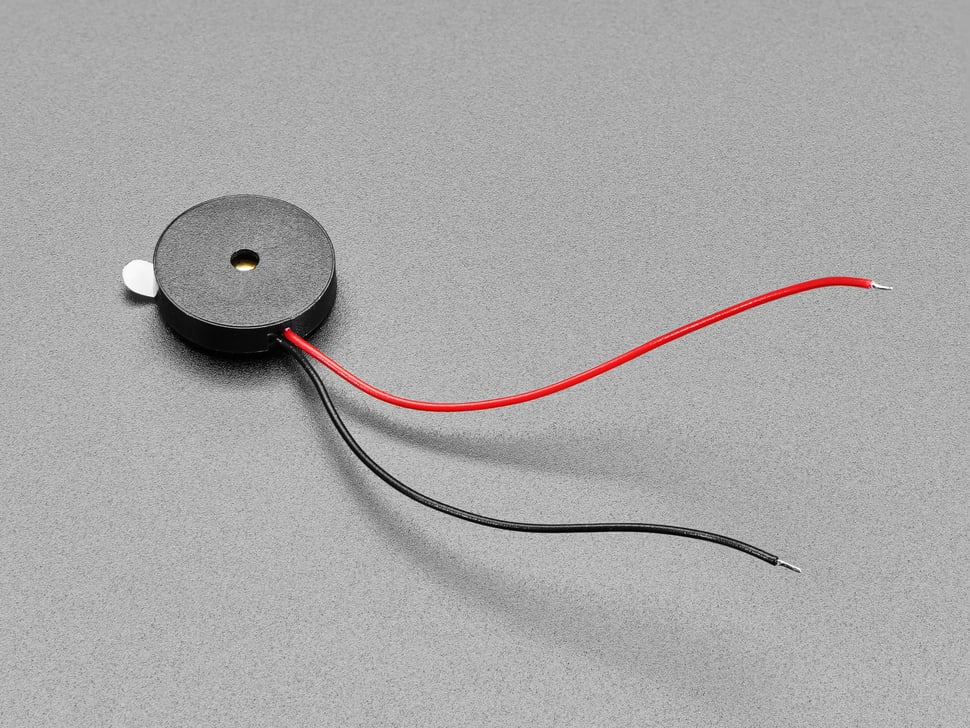 Picture of a small enclosed Piezo with Wires. Courtesy of adafruit.com